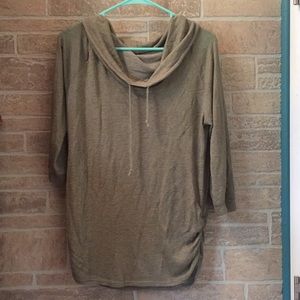 A quarter sleeved green top with a loose neckline